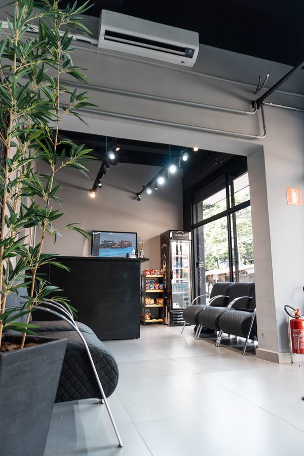 Recepcao da Box 04 com poltronas, TV e frigobar